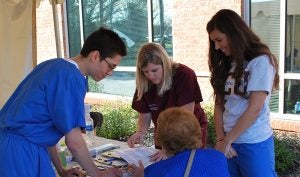 Dental students David Morrison, Ali Denny, and Madison Smith were part of the team that registered individuals to become patients at ECU Smiles.