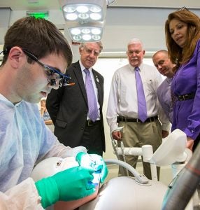 First-year dental student Luke Current works in a simulation lab as Dr. Greg Chadwick, dean of the school, and auditors Bill Kraus, Wayne Poole and Stacie Tronto observe.