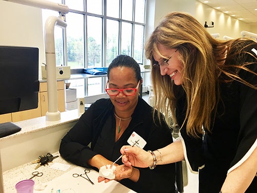 Dr. Isabel Gay, division director of periodontology, and surgical sciences colleagues offered instruction in dental implants for general dentists during a workshop at the dental school.