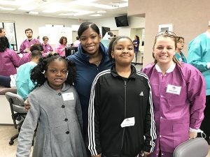 Kedra Peele values preventive dentistry for her daughters Keziyah (at left) and Kedriona. Third-year student Caitlin Ferguson provided cleanings and fluoride treatments for the girls during Give Kids a Smile â day in Greenville.