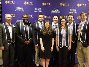  Omicron Kappa Upsilon (OKU) National Dental Honor Society inductees include (left to right) Dr. David Taylor, Dr. Raynald Desameau, Dr. Patrick Monahan, Ms. Peyton Absher, Dr. Luke Current, Dr. Morgan Stroud, Dr. Brett Leslie, and Dr. Bryson Rominger. Dr. Wanda Wright was unavailable for the photo.