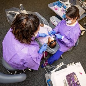 Dental hygienists Jennifer Buck (left) and Rachel Stewart provide cleanings, fluoride treatments and/or dental sealants as recommended for each child by a faculty dentist.