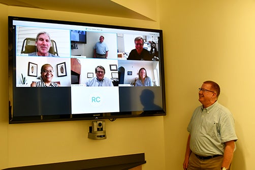 Members of the grant project team from the School of Dental Medicine and College of Allied Health Sciences meet via teleconference, led by principal investigator Dr. Michael Webb, right. (Photo by Jon Jones)