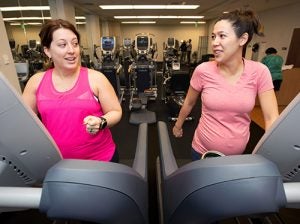 Jodie Messimer, left, and Lei Grigg warm up on a pair of treadmills before lifting weights during a prenatal exercise class at the East Carolina Heart Institute. (Photo by Rhett Butler)