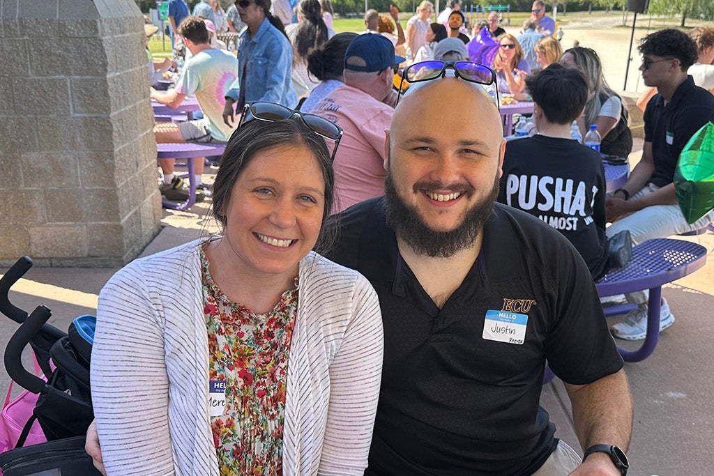Man and a woman sitting at a table.