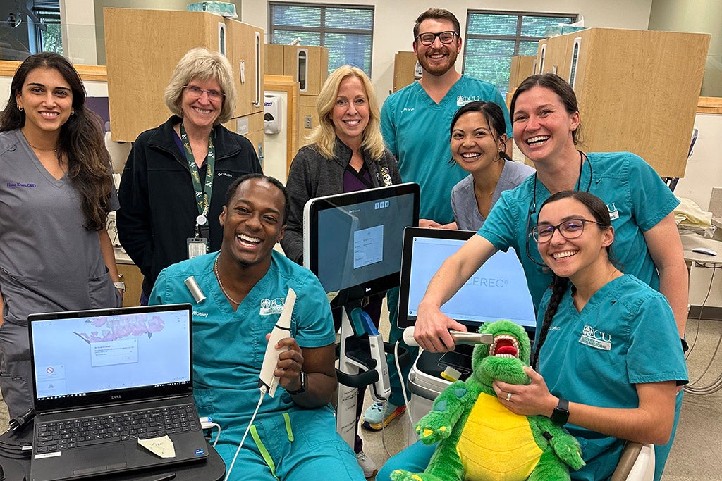 Dentists posing for a photo in a clinic.