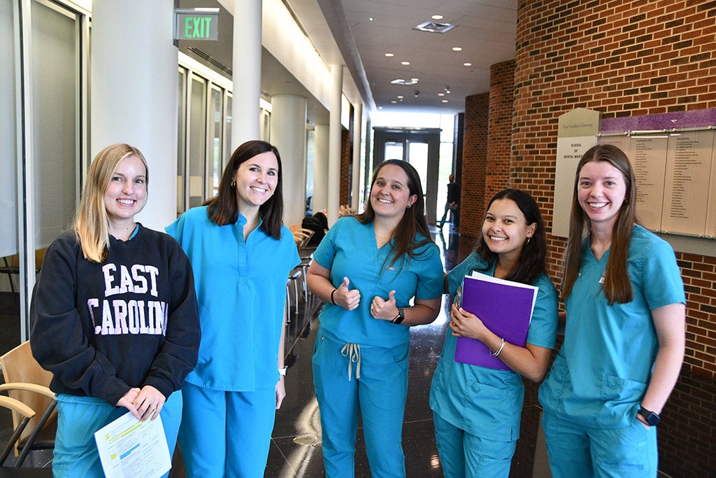 Students standing in the hall.