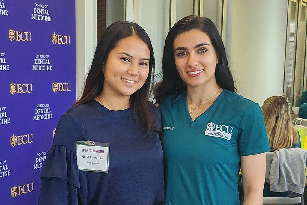 Two women posing for photo.