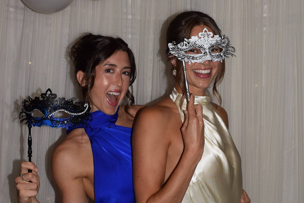 Two women with a mask on.