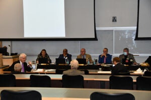 A photo of participants discussing the topics in a meeting room.