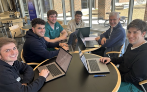 Groups of students sitting at a table.